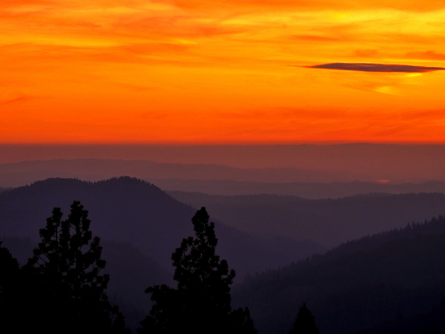 fiery sunset at the top of the mountain, looking across the mountain range